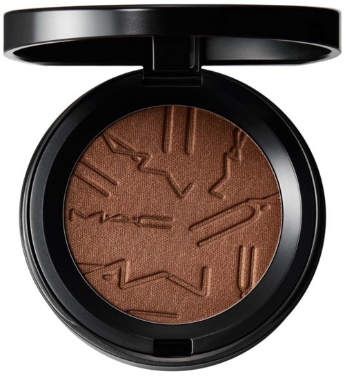 A brown powder eyeshadow with embossed clock and text, in a round black compact with an open lid.