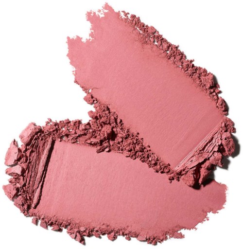 Broken pink cosmetic powder in a loose form, with one part smoother and the other rougher.