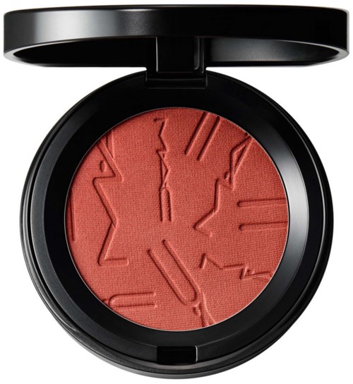 A red blush with star and clock designs, and a black round case with a lid.