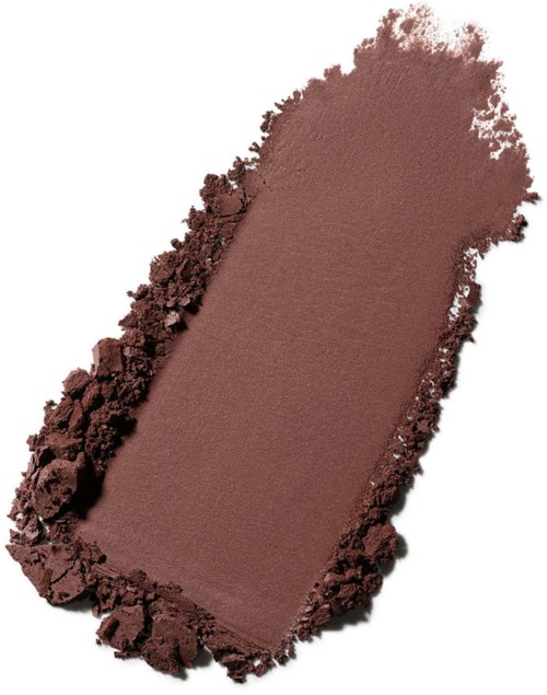 A makeup eyeshadow in a brown shade with a soft, smooth surface and rough edges.