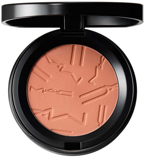 A makeup blush in a black compact case with a textured, geometric pattern on the surface.
