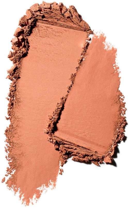 A peach-colored powder or makeup spread on a surface with a divided section showing different textures.
