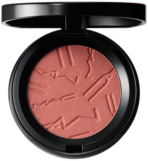 A round blush compact with a textured, abstract pattern in pink inside a black case.