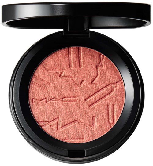 A round blush with geometric patterns engraved inside, housed in a black case with a lid.