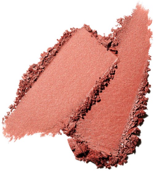 Two pieces of peach-colored crushed makeup or blush with rough edges and a soft, shimmery texture.