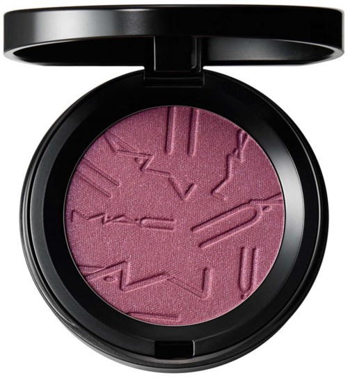 Pink blush with abstract raised lines inside, in a round black compact with a lid.