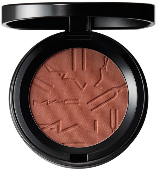 A compact of blush with raised abstract patterns, in a black round case with a lid.