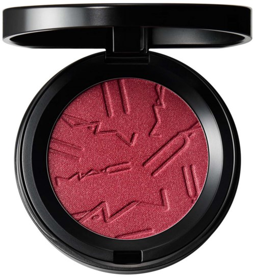 Red blush with geometric patterns in a round black compact case.
