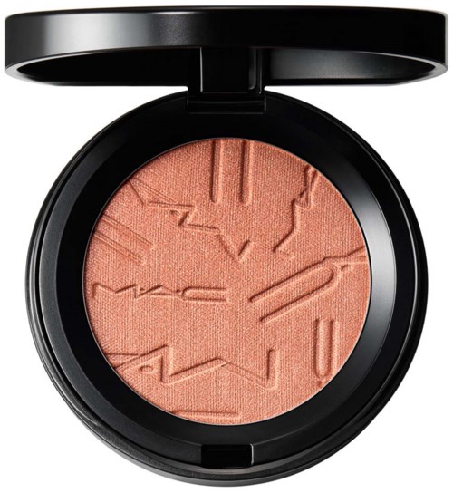 A makeup blush compact with embossed geometric shapes on peach-colored powder.