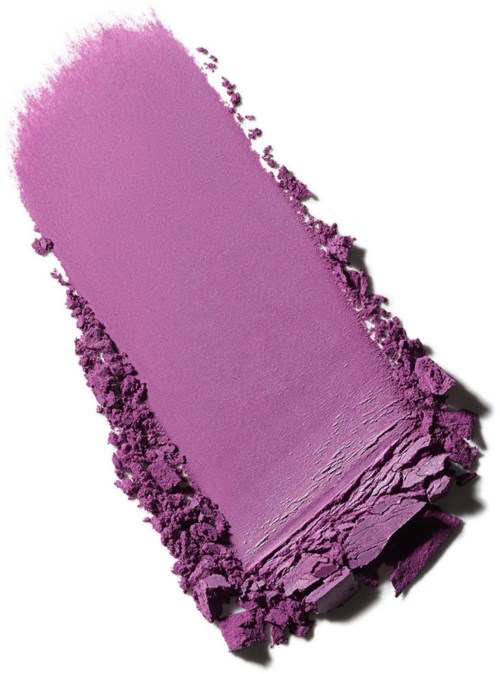 A purple makeup eyeshadow broken into pieces with some powder spilled around it.