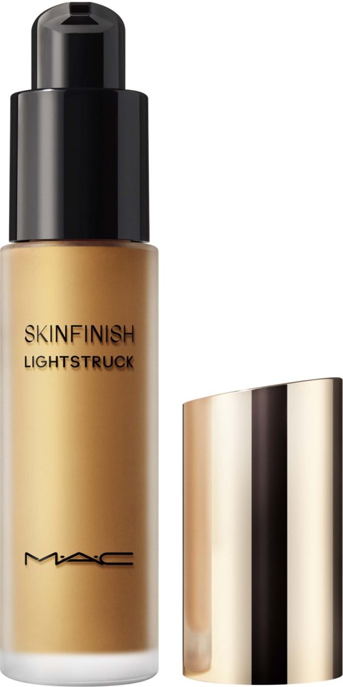 A bottle of MAC Skin Finish Lightstuck liquid highlighter with a pump, gold and black design, and a gold cap.