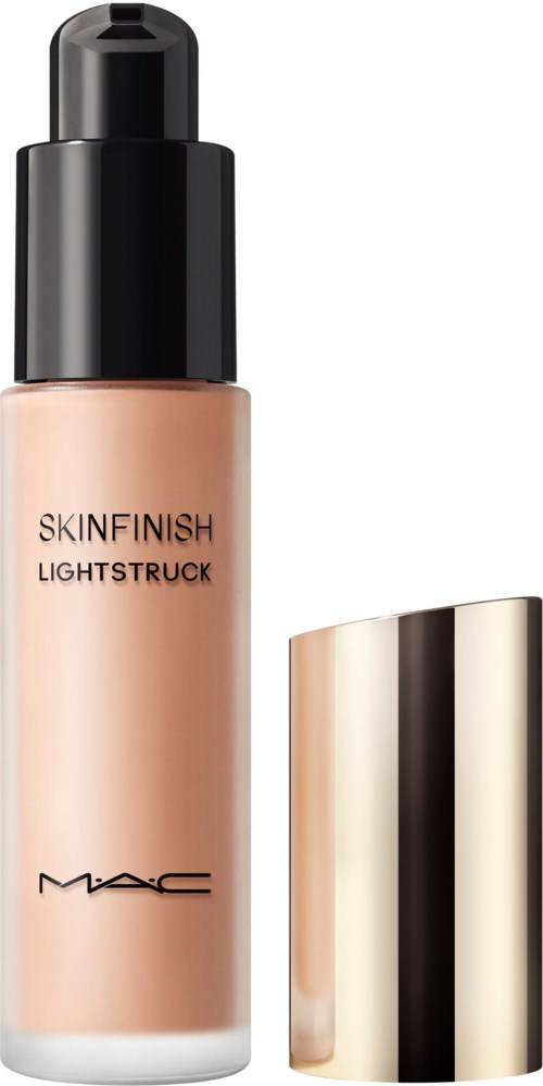 A bottle of MAC Skinfinish Lightstruck foundation with a black cap and gold lid beside it.