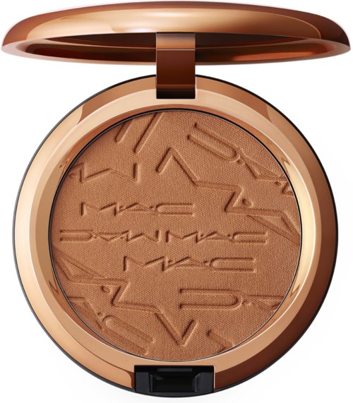 A round makeup compact with brown pressed powder inside and a shiny gold lid.