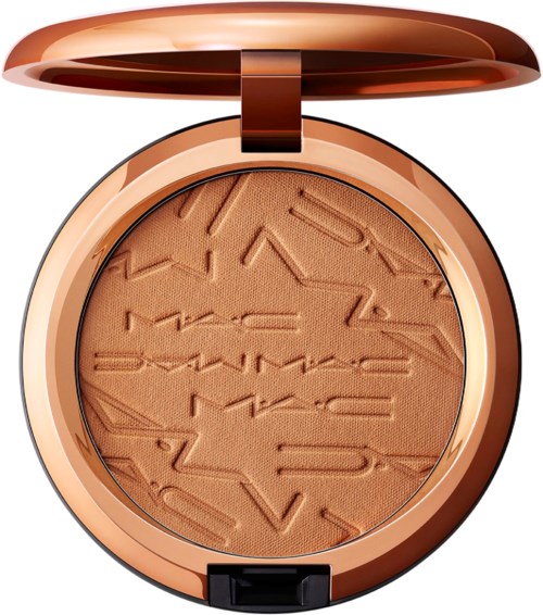A round makeup compact with a rose gold lid, containing peach-colored powder with embossed irregular lines and shapes.