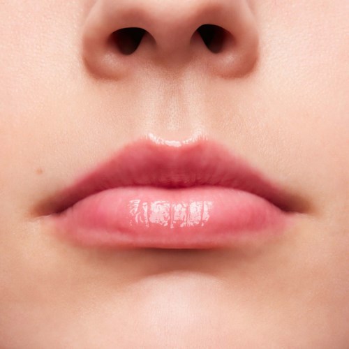 Close-up of lips and nose, smooth skin, no makeup, natural look.
