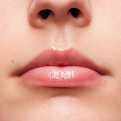 Close-up of lips and nose with clear skin and natural features.