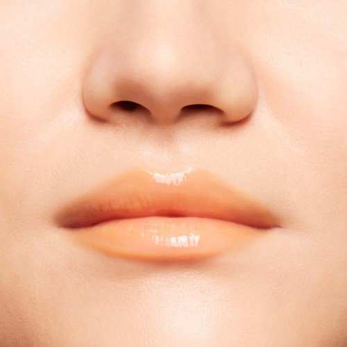 Close-up of lips with glossy, slightly parted appearance and clear skin.