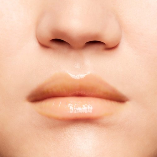 Close-up of lips and part of nose, smooth skin, no makeup, natural look.