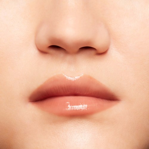 Close-up of lips and nose, smooth skin, natural look, soft lighting, minimal makeup.