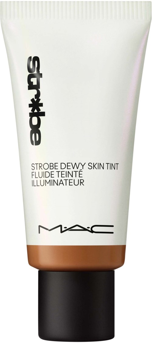 A tube of MAC Strobe Dewy Skin Tint with white and copper design, black cap, and product name written on it.