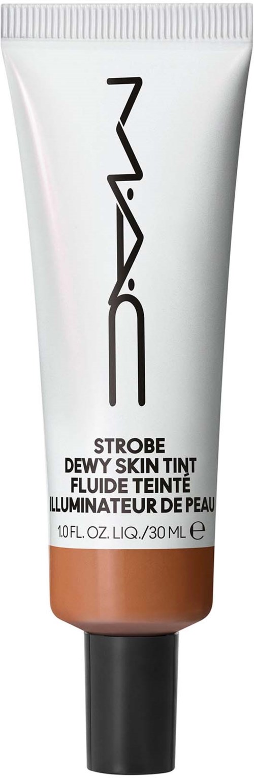 A tube of MAC strobe dewy skin tint with a black cap, white body, and orange-beige bottom section.