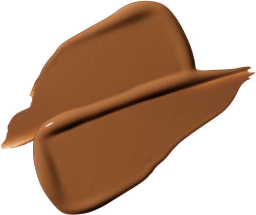 A spoon of smooth, creamy chocolate spread. The spread is partially on a spoon and partially dropped.