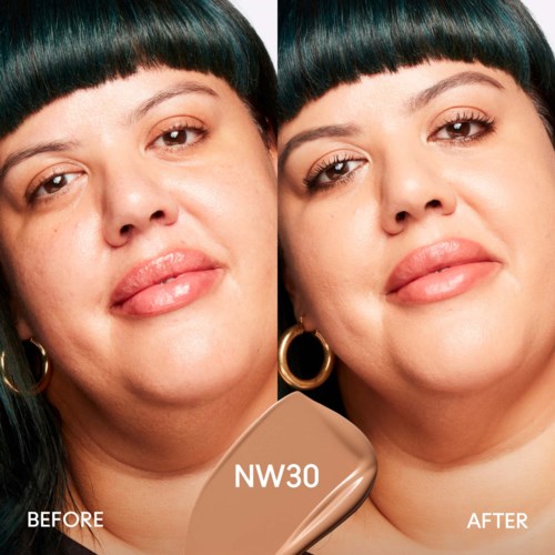 A woman with dark hair shows a side-by-side comparison, before and after applying makeup using NW30 shade.