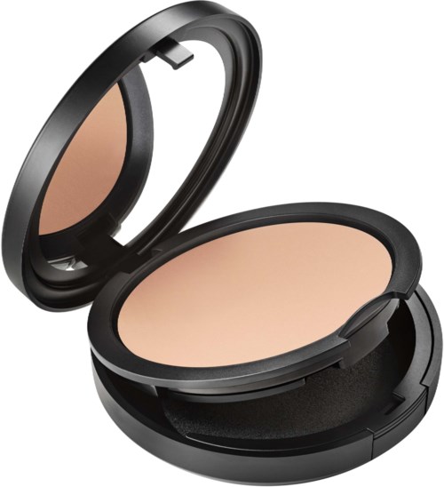 A compact makeup powder case with a mirror inside, holding beige powder.