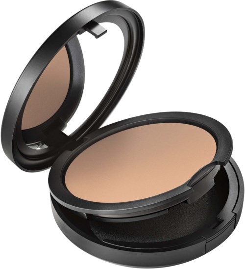 A compact makeup mirror and powder case with a beige powder inside.