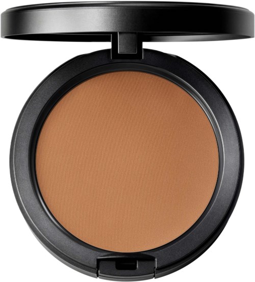 A compact makeup powder in a black case with a lid. The powder is light brown, smooth, and round.