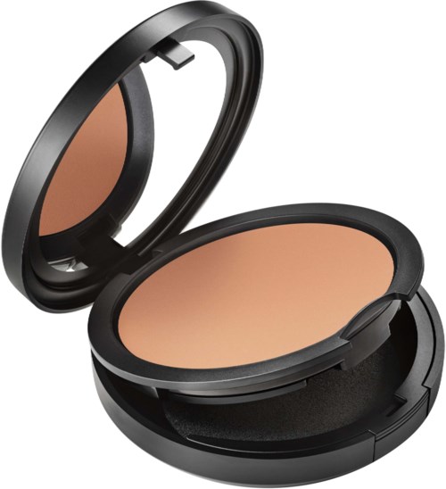 A compact, round makeup powder with a mirror inside the lid. It has beige-colored powder and a black case.