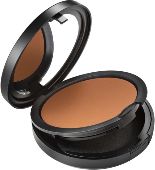 A compact makeup mirror contains a pressed powder product with a tan color.