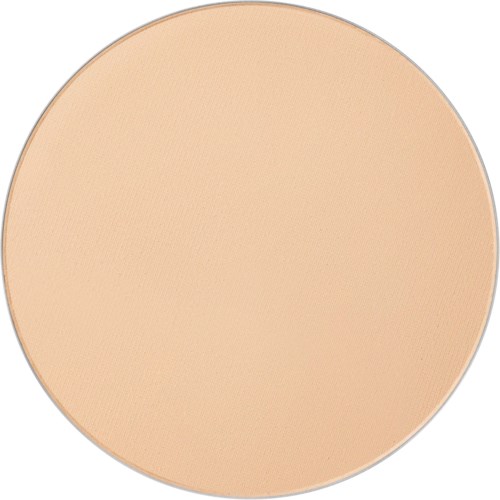 A large, round, beige-colored makeup compact with a smooth surface.