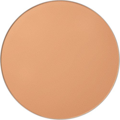 En rund compact av beige pudder med jevn overflate.