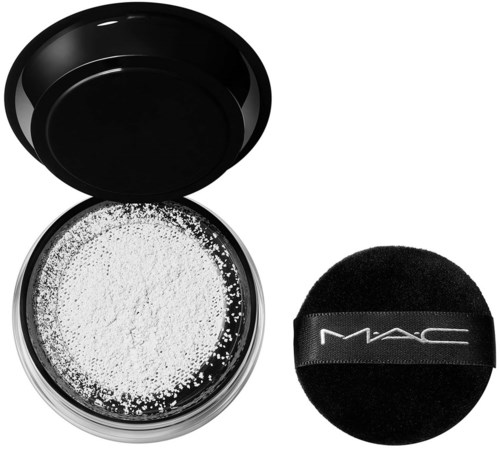 A container with white powder and a black sponge applicator for makeup.