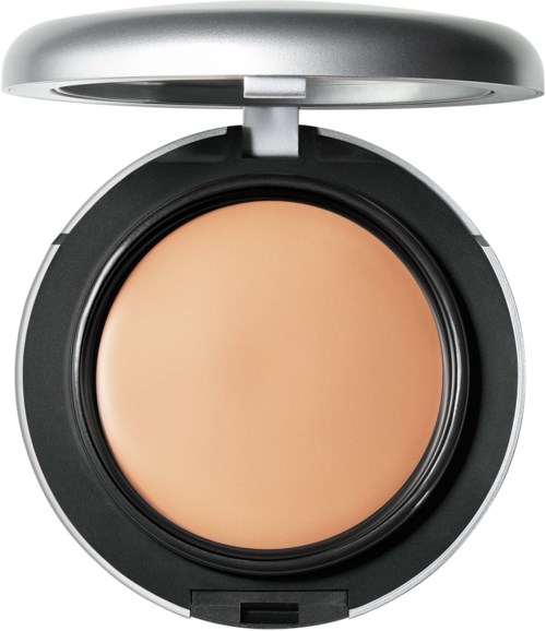 A compact makeup product with a beige color inside, surrounded by a silver and black casing, with a lid open.