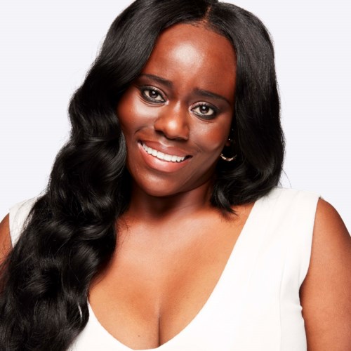 A woman with long black hair, wearing a white top, smiling gently against a plain background.