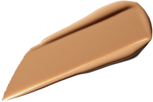 En glatt, beige flytende foundationprøve på hvit bakgrunn.