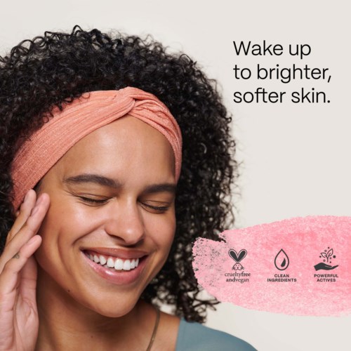 A woman with curly hair and a pink headband smiling, touching her face, promoting bright, soft skin. Text highlights benefits.