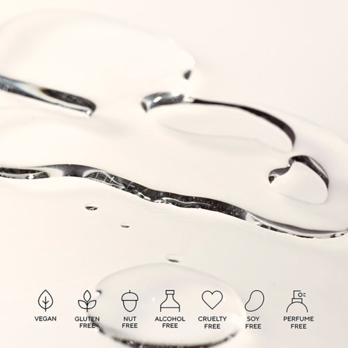 The image shows a creamy liquid with icons indicating it is vegan, gluten-free, nut-free, alcohol-free, cruelty-free, soy-free, and perfume-free.