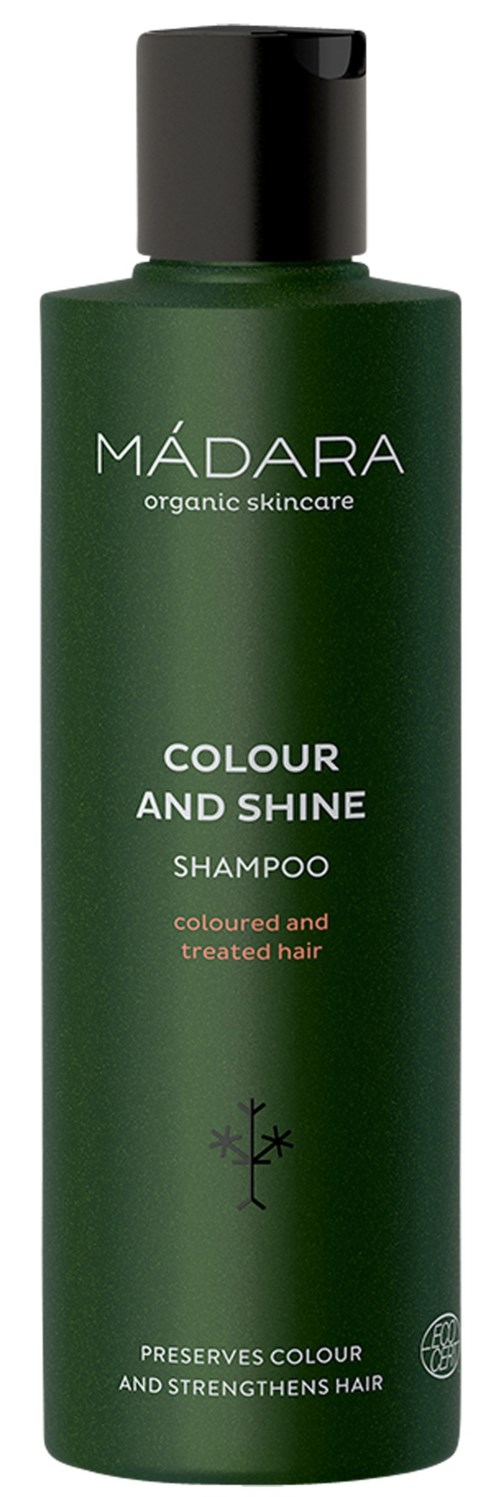 Green shampoo bottle with black cap, labeled 'MÁDARA' for colored and treated hair.