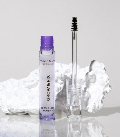 A small purple bottle labeled 'Brow & Lash Fix' with a wand applicator stands next to a white cloud-like object.