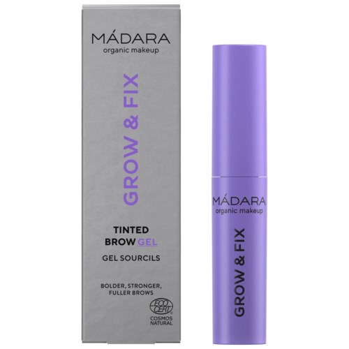 A purple brow gel tube stands next to a gray box labeled 'MÁDARA organic makeup' for growing and fixing eyebrows.