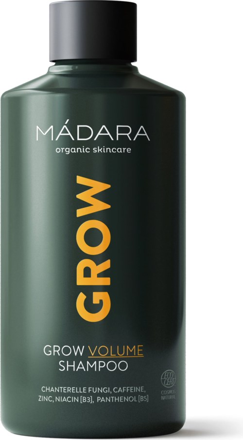 Dark green bottle of MÁDARA Grow Volume Shampoo with black cap, label shows product details and ingredients.