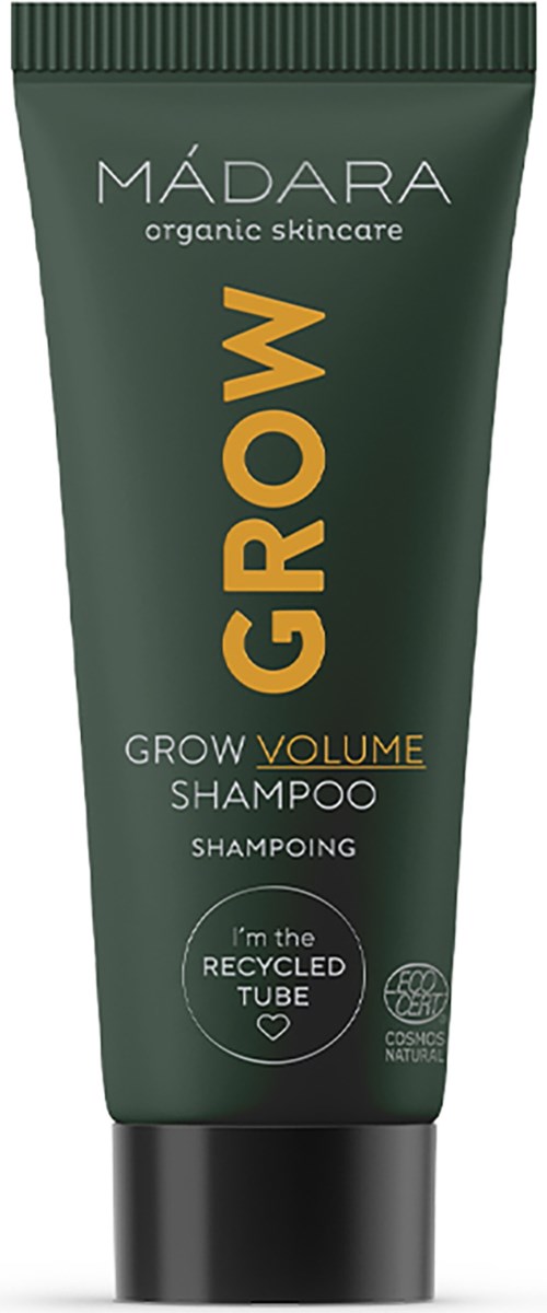 Grönt rör med MADARA Grow Volume Shampoo och svart lock. Texten betonar ekologisk hudvård och återvunnen tub.