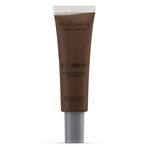 A brown tube of Madara organic makeup sunscreen with a white cap. Text on the tube describes it as foundation.
