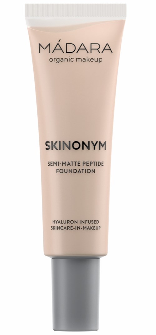 A tube of MÁDARA SKINONYM foundation, labeled as semi-matte, with information about hyaluronic acid and organic makeup.