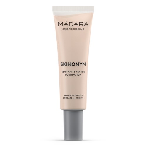 A tube of foundation labeled MADARA organic makeup with skincare ingredients, including hyaluronic acid, in a light pink color.