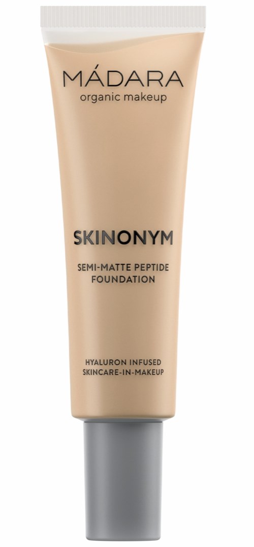 A beige tube labeled 'MADARA organic makeup, SKIN ON MYM, semi-matte peptide foundation, hyaluronic infusion, skincare-in-makeup.'