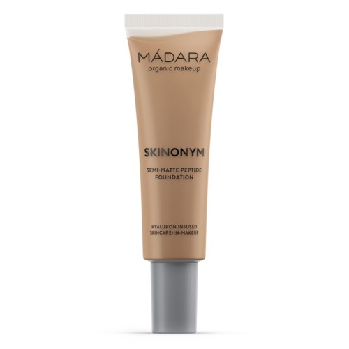 Brown tube of Mádara organic makeup foundation with silver cap, labeled as semi-matte with hyaluronic acid.